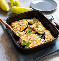 Roasted peppers stuffed with cheese and herbs in baking tray. Healthy Meatless Meal. Characteristic dish of the Balkan cuisine. Serbian cuisine. Gray background, close-up, selective focus