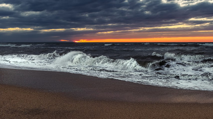 Stormy sea at sunset time