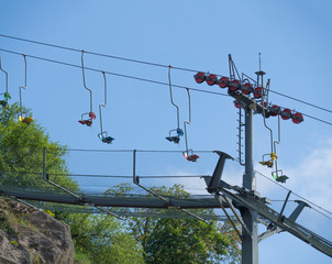 Empty colorful old chair lift, funicular, in Prague ZOO and cable car. Blue sky background.