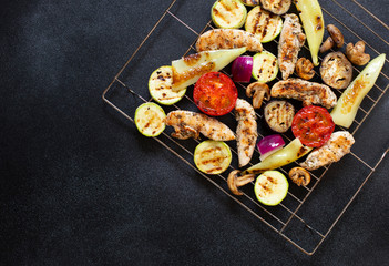 Grilled Chicken and Vegetables, Tomatoes, Peppers, Onions, Eggplants and Zucchini . Healthy diet food. Healthy dinner. Low fat content. Top view, black background, copy space
