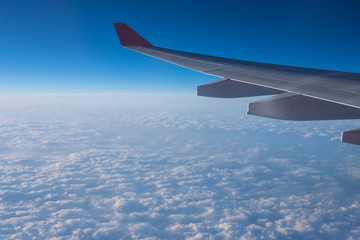 Fototapeta na wymiar View from a plane window above the cloud.
