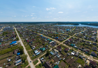 Sysert city. Russia. Aerial. City with low private houses, long streets and pond. Sunny, summer