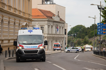 Ambulance vehicle on the street, with Police in background, securing public event in Belgrade