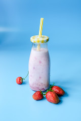 Bowl with red strawberries at dark wooden background,closeup