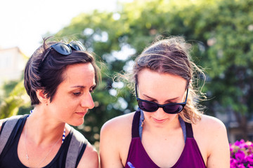 Lifestyle photography. Two happy and urban lesbian girlfriends in a sunny day in summer