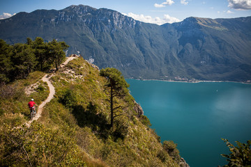 LAKE GARDA, ITALY - A mountain biker riding a narrow precipitous trail high above Lake Garda.
