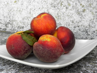 fresh red peaches on a plate