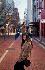 Stylish woman raising hands up for positive feeling and celebrat