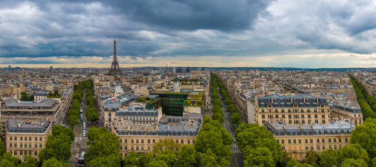 Great aerial panorama picture of the Paris cityscape with the famous and iconic Eiffel Tower including Avenue d'Iéna, Avenue Kléber and Avenue Victor-Hugo on a cloudy day.