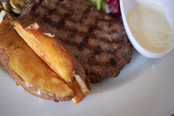 Hamburger, roasted potatoes and salad