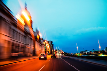 Driving at dusk through the streets of Dublin City, Ireland. Speed blur of orange lights and blue...