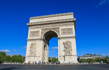 Fototapeta na wymiar Perfect view of the Arc de Triomphe seen from the east with the two sculptures Le Départ and Le Triomphe on a nice sunny day with a beautiful blue sky. It is one of the most famous monuments in Paris.