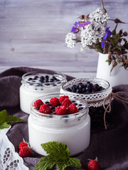 Milk yogurt with blueberries, raspberries, detox. Copy space.
