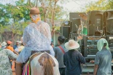 Young man riding horse with music band in ordination ceremony in buddhist Thai monk ritual for change man to monk in ordination ceremony in buddhist in Thailand