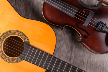 Classical violin and guitar on wooden background. Traditional musical instruments