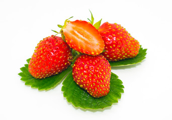 Red strawberries on a green leaf. Still-life. 