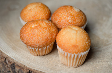 Close-up of cupcakes on wooden board. Sweets for breakfast.