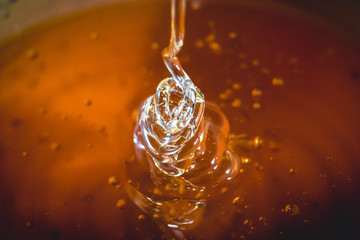 honey dripping from spoon close up. golden honey close up.