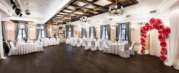 Front view at an interior of a banquet hall ready for wedding