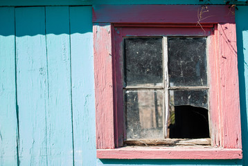 Naklejka na ściany i meble teal blue country wood building red old broken window