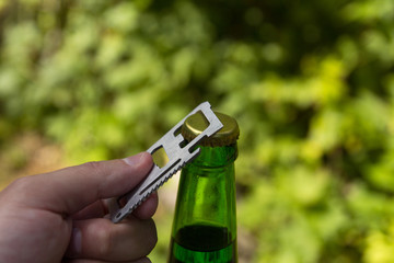 Glass transparent green glass bottle. With a cork and a bottle opener.