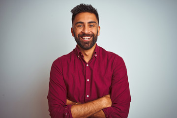 Young indian man wearing red elegant shirt standing over isolated grey background happy face...