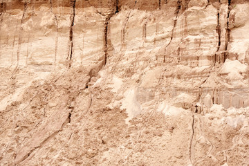 Closeup texture of sand in sand quarry. Sand wall in the cracks in the sand quarry.