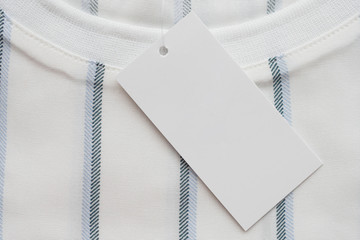 Blank white clothes tag label on new shirt