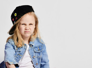 Little cute girl blonde in a cap wearing a visor back