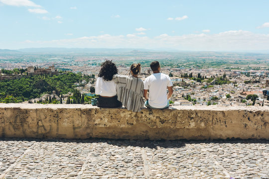 Group of friends doing tourism in Spain and contemplating the panoramic views of the Alhambra in Granada