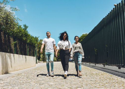 Group of friends posing serious and insulting the camera. real people on a sunny day