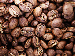 Fresh delicious organic crafted medium dark roasted Mexican arabica coffee beans background vintage film color
