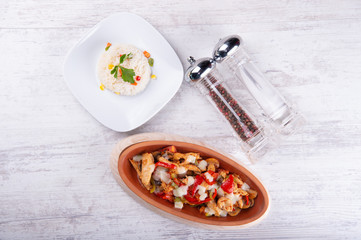 Chicken fajita with rice, salt and black pepper on white wood background