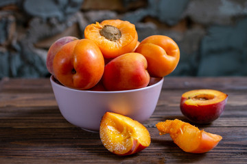 apricots in a bowl on wooden table