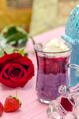 Mahalabia - Traditional Middle Eastern Dessert. Creamy dessert with berries and yogurt cream.