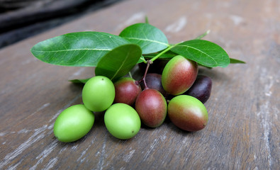 Carunda or Karonda. Karonda Fruit with wood background. Closeup the Carunda or Karonda fruit.