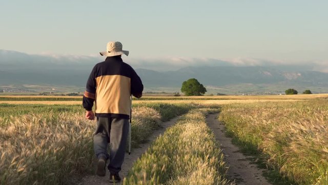 Elderly pilgrim walking on famous pilgrimage route of camino de Santiago, Spain .