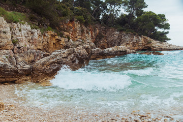 rocky beach view on overcast weather. wallpaper background