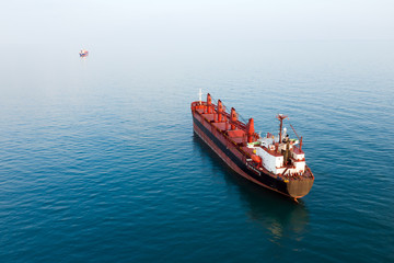 Aerial view of high-speed sea vessel for transportation of a cargo vessel at high speed is drifting...