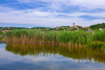 Tihany abbey at lake Balaton from the inner laker with reed and reflection on the water