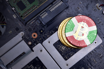 golden bitcoins with flag of burundi on a computer electronic circuit board. bitcoin mining concept.