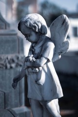 statue of angel with cross