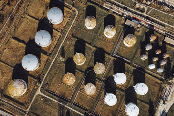 Aerial view of large aluminum containers with flammable fuel. Storage of petroleum products. Barrels of oil. Drone