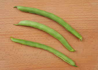 Young pods of asparagus haricot on a wooden surface