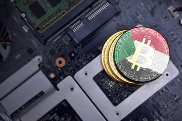 golden bitcoins with flag of sudan on a computer electronic circuit board. bitcoin mining concept.