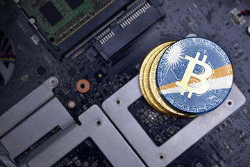 golden bitcoins with flag of Marshall Islands on a computer electronic circuit board. bitcoin...