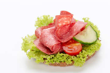 Sandwich with salami sausage on white background.