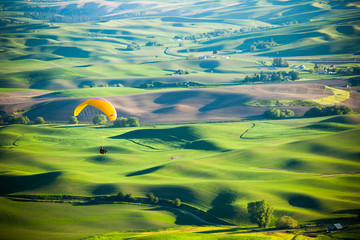 A man paragliding off Steptoe Butte in eastern Washington State.