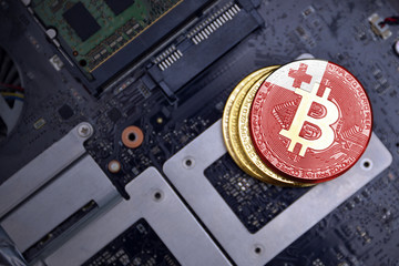 golden bitcoins with flag of Tonga on a computer electronic circuit board. bitcoin mining concept.