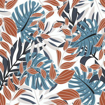 Trend seamless pattern with colorful tropical leaves and plants on a delicate background. Vector design. Jungle print. Floral background. Printing and textiles. Exotic tropics. Fresh design.